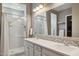 Modern bathroom featuring dual sinks, a large mirror, and a glass-enclosed shower at 11609 W Andrew Ln, Peoria, AZ 85383