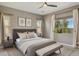 Comfortable primary bedroom with a ceiling fan, and two windows allowing lots of natural light at 11609 W Andrew Ln, Peoria, AZ 85383