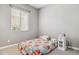 Charming bedroom with a window, soft carpet, and a bed adorned with a floral pattern at 11609 W Andrew Ln, Peoria, AZ 85383