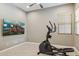 Spacious bonus room featuring an elliptical machine and a large wall-mounted TV at 11609 W Andrew Ln, Peoria, AZ 85383