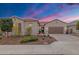 Charming single-story home with tile roof, desert landscaping, and an attached two-car garage at 11609 W Andrew Ln, Peoria, AZ 85383