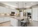 Modern kitchen featuring white cabinetry, a granite island, and stainless steel appliances at 11609 W Andrew Ln, Peoria, AZ 85383