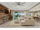 Bright living room features wood accent wall, neutral sectional, area rug, and access to backyard at 11609 W Andrew Ln, Peoria, AZ 85383