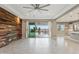 Bright, open-concept living room with wood accent wall, sliding glass door to the backyard and an open kitchen at 11609 W Andrew Ln, Peoria, AZ 85383