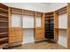 Spacious walk-in closet with custom wood shelving, drawers, and ample storage space at 11609 W Andrew Ln, Peoria, AZ 85383