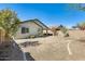 Large backyard with desert landscaping, mature trees, and lush green grass at 11988 W Nadine Way, Peoria, AZ 85383
