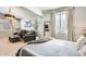 Bright bedroom with sitting area, plantation shutters, and a full-length mirror reflecting the room at 11988 W Nadine Way, Peoria, AZ 85383