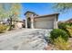 Inviting one-story home with a two-car garage, neutral paint, and drought-tolerant landscaping in the front yard at 11988 W Nadine Way, Peoria, AZ 85383