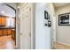 Hallway view leading to a kitchen with wood cabinets and dark countertops at 11988 W Nadine Way, Peoria, AZ 85383