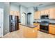 Spacious kitchen featuring stainless steel appliances, wood cabinets, and an island at 11988 W Nadine Way, Peoria, AZ 85383