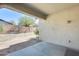 Covered patio view of spacious backyard with a beige wall at 11988 W Nadine Way, Peoria, AZ 85383