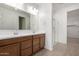 Modern bathroom with double sink vanity, large mirror, and a glass-enclosed shower at 12366 W Marguerite Ave, Avondale, AZ 85323