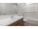 Bathroom with double vanity, white countertops, bathtub, and bright lighting at 12366 W Marguerite Ave, Avondale, AZ 85323