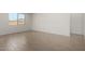 Bright bedroom with neutral walls and tile flooring, offering a simple, clean aesthetic at 12366 W Marguerite Ave, Avondale, AZ 85323