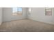 Bright bedroom with neutral carpet, white walls, and ample natural light from multiple windows at 12366 W Marguerite Ave, Avondale, AZ 85323