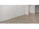 Spacious living room with durable tile flooring and fresh white paint at 12366 W Marguerite Ave, Avondale, AZ 85323