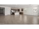 Open living space connecting seamlessly to a modern kitchen with stainless steel appliances and a spacious island at 12366 W Marguerite Ave, Avondale, AZ 85323