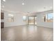 Open living space with tile flooring, connecting to a modern kitchen and outdoor views at 12366 W Marguerite Ave, Avondale, AZ 85323