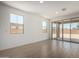 Bright living area with sliding glass doors opening to the patio, and neutral tile flooring at 12366 W Marguerite Ave, Avondale, AZ 85323