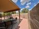 Covered back patio with outdoor seating overlooking the gravel and block fence at 1314 W Kingbird Dr, Chandler, AZ 85286