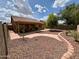 Large backyard features a covered patio and drought-tolerant landscaping, perfect for outdoor living at 1314 W Kingbird Dr, Chandler, AZ 85286