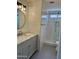 Bathroom with a glass shower, gray vanity, large mirror, and modern lighting at 1314 W Kingbird Dr, Chandler, AZ 85286