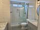 Bathroom features white tile, a glass shower, gray vanity, and modern fixtures at 1314 W Kingbird Dr, Chandler, AZ 85286