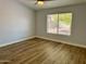 Bedroom with beautiful wood floors, a ceiling fan, and a bright window with backyard view at 1314 W Kingbird Dr, Chandler, AZ 85286
