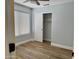 Bedroom with laminate wood floors, a window, and a closet with white sliding doors at 1314 W Kingbird Dr, Chandler, AZ 85286