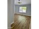 Bedroom with laminate wood floors, a ceiling fan, and a bright window with backyard view at 1314 W Kingbird Dr, Chandler, AZ 85286