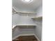 Walk-in closet featuring shelving, wood racks, and light gray walls at 1314 W Kingbird Dr, Chandler, AZ 85286