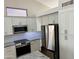 Updated kitchen with stainless steel appliances and white cabinetry at 1314 W Kingbird Dr, Chandler, AZ 85286