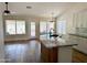 Open-concept kitchen with granite island, sleek fixtures, and hardwood floors at 1314 W Kingbird Dr, Chandler, AZ 85286