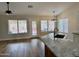 Kitchen with granite island and a seamless flow to the backyard, offering natural light at 1314 W Kingbird Dr, Chandler, AZ 85286