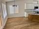 Kitchen features white cabinets, granite countertops, wood flooring, and stainless steel appliances at 1314 W Kingbird Dr, Chandler, AZ 85286