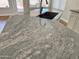 Modern kitchen island featuring granite countertops and a stainless steel sink at 1314 W Kingbird Dr, Chandler, AZ 85286