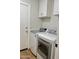 Bright laundry area with white cabinets and modern washer and dryer units at 1314 W Kingbird Dr, Chandler, AZ 85286