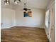 Living room features wood floors, vaulted ceilings, a ceiling fan, and large windows at 1314 W Kingbird Dr, Chandler, AZ 85286