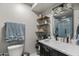 Bathroom featuring modern vanity, stylish shelves, and sleek fixtures with blue shower at 13419 N 35Th St, Phoenix, AZ 85032