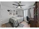 Cozy bedroom featuring a queen-sized bed, neutral decor, and a dedicated desk area for work or study at 13419 N 35Th St, Phoenix, AZ 85032