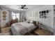 Bright bedroom with a wooden platform bed, neutral bedding, and hat display at 13419 N 35Th St, Phoenix, AZ 85032