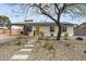 Charming home featuring solar panels, a bright yellow front door, and desert landscaping at 13419 N 35Th St, Phoenix, AZ 85032