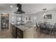 Spacious kitchen featuring an island cooktop, modern black range hood, and adjacent dining area for gatherings at 13419 N 35Th St, Phoenix, AZ 85032
