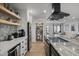 Open-concept kitchen featuring a large island with stove, a walk-in pantry, and seamless flow to the living area at 13419 N 35Th St, Phoenix, AZ 85032