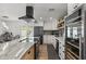 Contemporary kitchen featuring a center island with a cooktop, stainless appliances, and a beverage cooler at 13419 N 35Th St, Phoenix, AZ 85032
