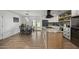 Open kitchen and dining area featuring a large island with stone countertops and stainless appliances at 13419 N 35Th St, Phoenix, AZ 85032