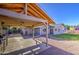 Spacious backyard with a covered patio, built-in grill, and well-maintained lawn perfect for outdoor entertaining at 1357 S Loma Vis, Mesa, AZ 85204