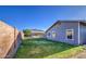 Large, grassy backyard with a privacy wall; view of the house and a covered patio at 1357 S Loma Vis, Mesa, AZ 85204