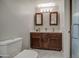Bathroom with double vanity, wood cabinets, marble countertop, and modern lighting at 1357 S Loma Vis, Mesa, AZ 85204