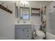 Neutral bathroom with vanity, wood shelves, decorative shower curtain and hardware at 1357 S Loma Vis, Mesa, AZ 85204